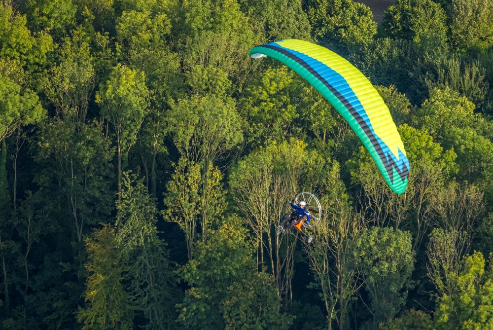 Werl from above - Motorized paraglider in flight over the airspace over a forest area in Werl at Ruhrgebiet in the state North Rhine-Westphalia, Germany