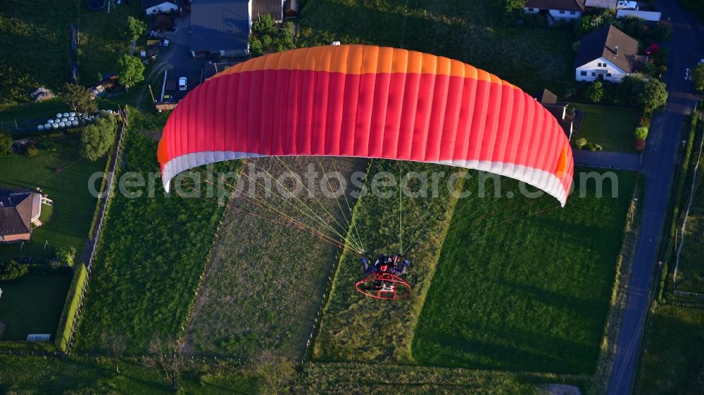 Königswinter from the bird's eye view: Motorized paraglider in flight over the airspace in Koenigswinter in the state North Rhine-Westphalia, Germany