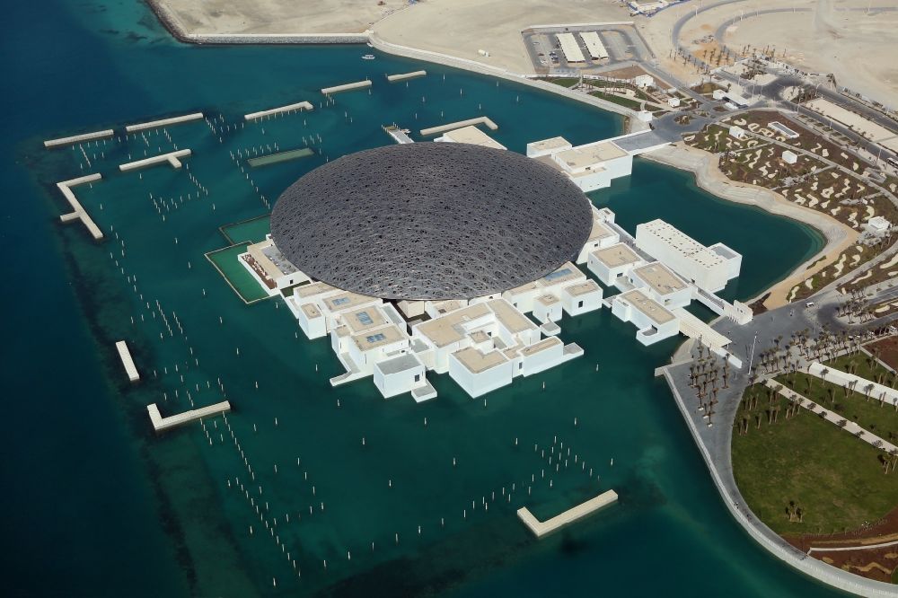 Abu Dhabi from above - Museum building ensemble Louvre Abu Dhabi with the giant dome on the Saadiyat Island in Abu Dhabi in United Arab Emirates
