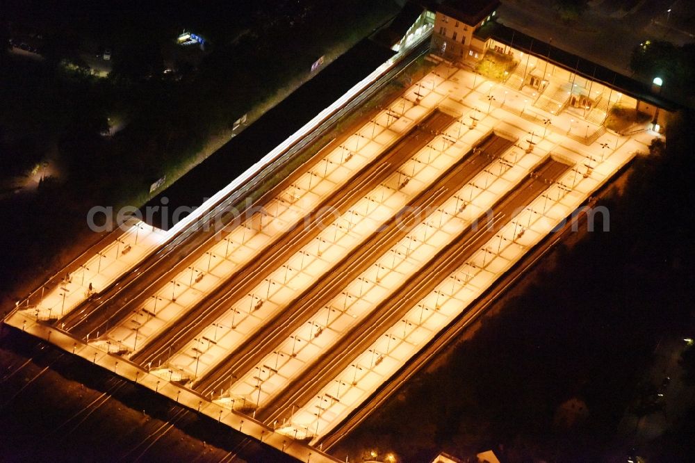Aerial image Berlin - Night view Station building and track systems of the suburban train station Olympiastadion of the S-Bahn Berlin GmbH in the Flatowallee near to the olympic stadium in Berlin