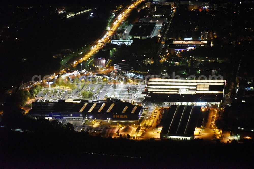 Berlin from above - Night view of the furniture store IKEA in the Schoeneberger Strasse in Berlin-Tempelhof. Next to IKEA a branch of Bauhaus building supplies store