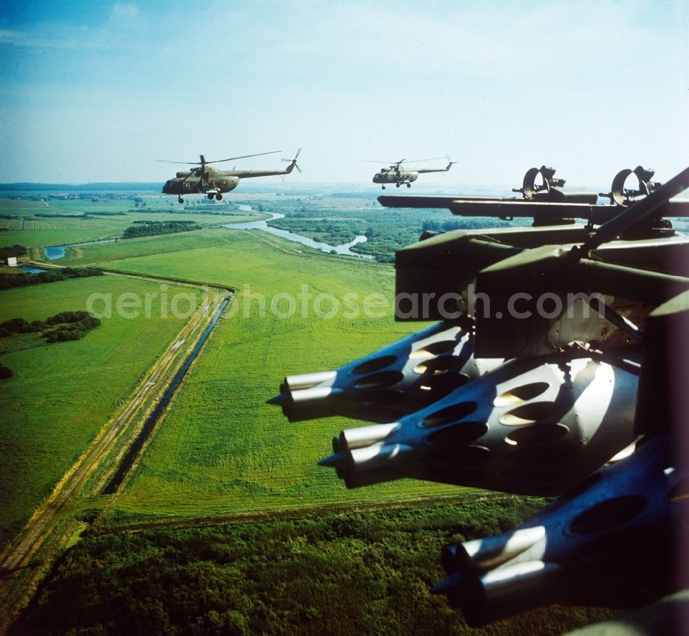 Aerial image Peenemünde - Close-up of 3 missile launching containers (rocket container) UB-32 to the arms weapons attack helicopter Mil Mi 8 of the NVA in Peenemuende in Mecklenburg-West Pomarania. In the background, more support and helicopter gunships