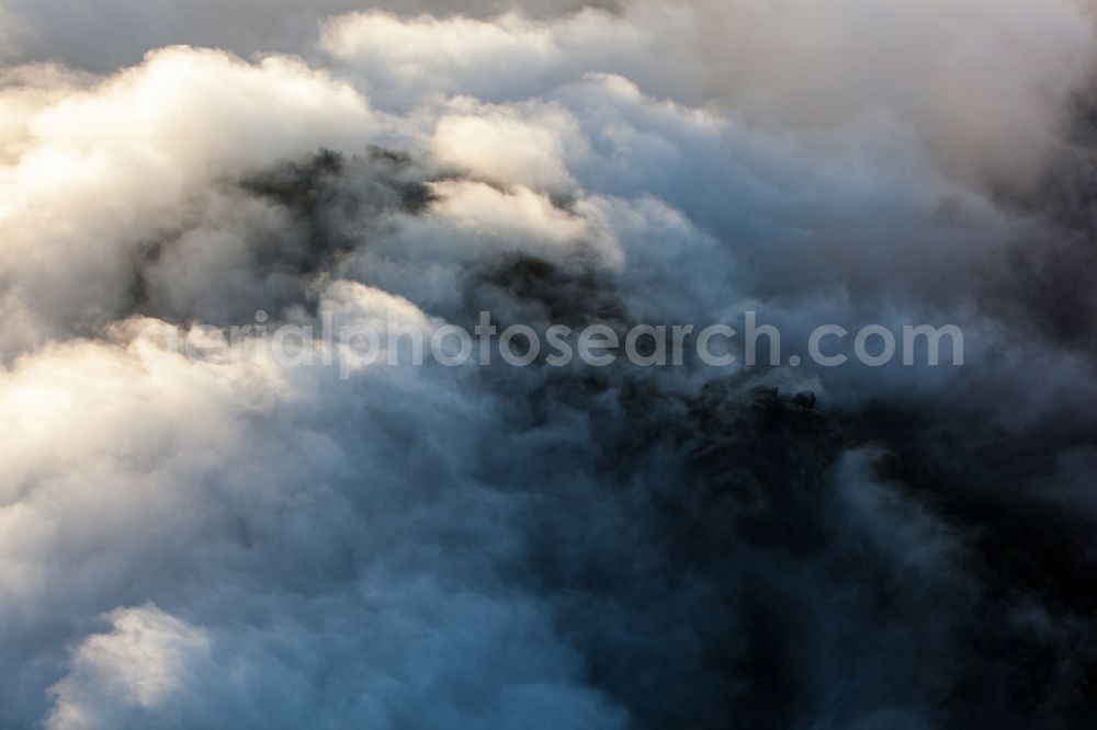Sächsische Schweiz from above - Nature - Landscape of clouds and haze surrounding mountains in Saxon Switzerland in Saxony. The scenery on the banks of the Elbe is part of the Saxon Switzerland National Park