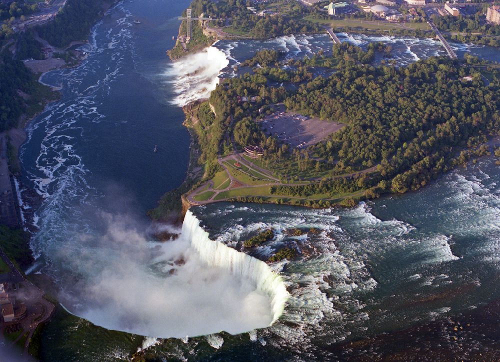 Aerial image Niagara Falls - Natural spectacle of the Niagara Falls on Niagara River on street Niagara River Parkway in Niagara Falls in Ontario, Canada. The larger Horseshoe Falls in Canada and the American Falls in the United States