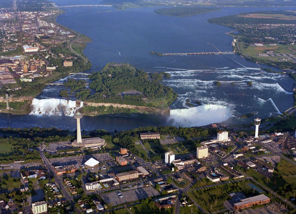 Aerial photograph Niagara Falls - Natural spectacle of the Niagara Falls on Niagara River on street Niagara River Parkway in Niagara Falls in Ontario, Canada. The larger Horseshoe Falls in Canada and the American Falls in the United States