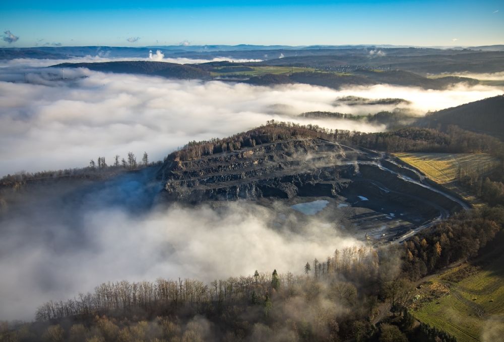 Arnsberg from above - Weather related fog banks and cloud layer above a quarry for the extraction and extraction of limestone in Arnsberg at Ruhrgebiet in the state North Rhine-Westphalia, Germany