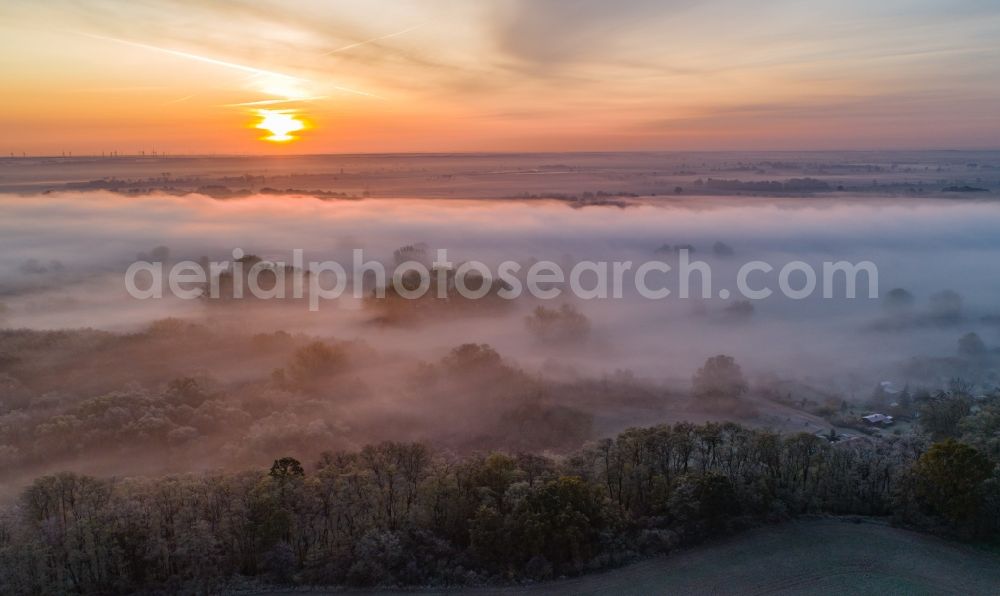Aerial photograph Klessin - Weather related fog banks and cloud layer by sunset over a forest area in Klessin in the state Brandenburg, Germany