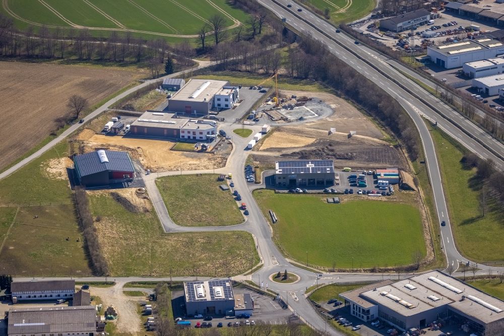 Aerial image Meschede - New building construction site in the industrial park Auf dem Bruch overlooking the company buildings of Eventtechnik Suedwestfalen and the JUMA Logistik GmbH in the district Enste in Meschede in the state North Rhine-Westphalia, Germany