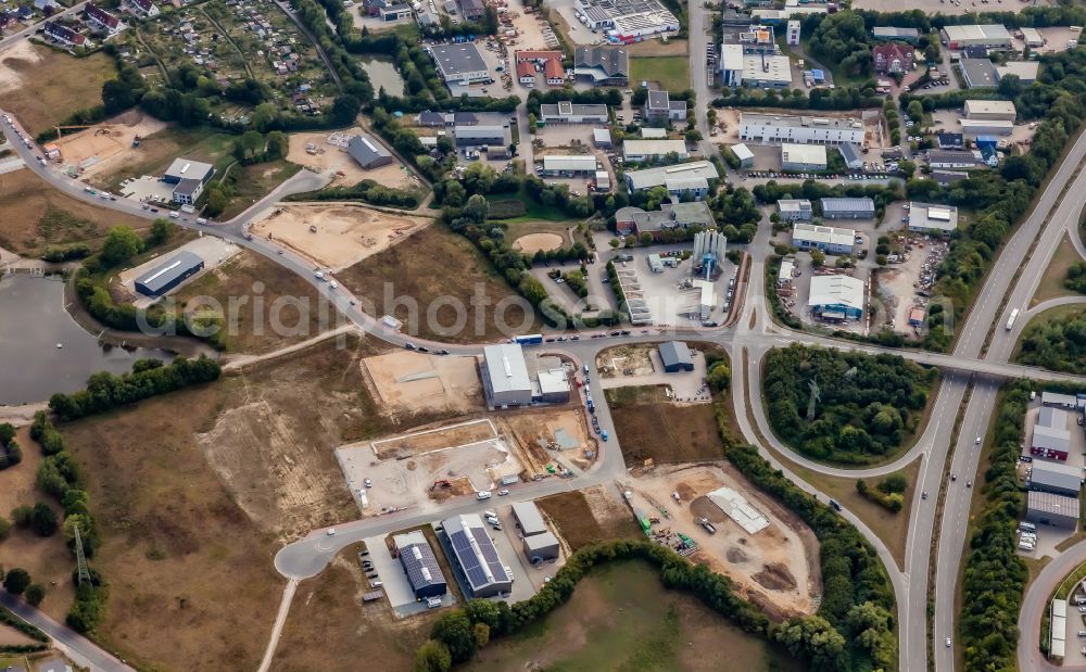 Schönkirchen from above - New construction site in the commercial area along the street Pahlbloken on the federal highway B502 in Schoenkirchen in the state Schleswig-Holstein, Germany