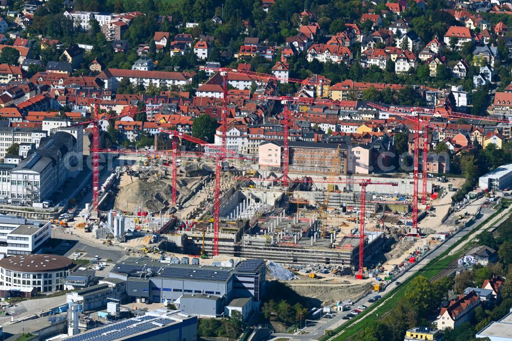 Aerial photograph Jena - Construction site for the new construction of an office and commercial building for the new company headquarters for the Medical Technology and Research Microscopy Solutions division of Carl Zeiss Meditec AG and Carl Zeiss AG on street Otto-Schott-Strasse in Jena in the state of Thuringia, Germany
