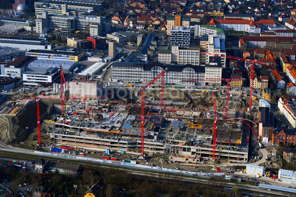 Jena from the bird's eye view: Construction site for the new construction of an office and commercial building for the new company headquarters for the Medical Technology and Research Microscopy Solutions division of Carl Zeiss Meditec AG and Carl Zeiss AG on street Otto-Schott-Strasse in Jena in the state of Thuringia, Germany