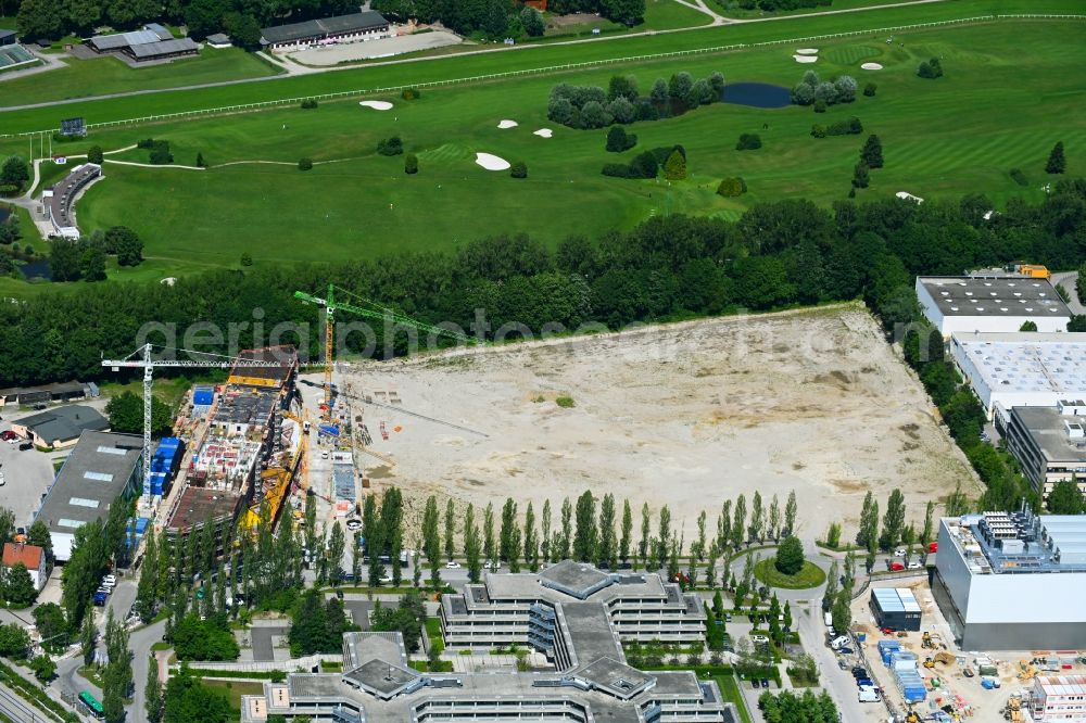 Aschheim from above - Construction site to build a new office and commercial building at the development area on Karl-Hammerschmidt-Strasse in the district Dornach in Aschheim in the state Bavaria, Germany
