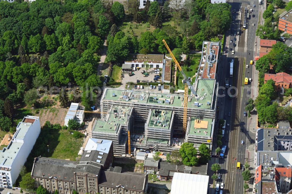 Berlin from the bird's eye view: Construction site to build a new office and commercial building on the site of the former UCI film theater and cinema building on Landsberger Allee in the district Friedrichshain in Berlin, Germany