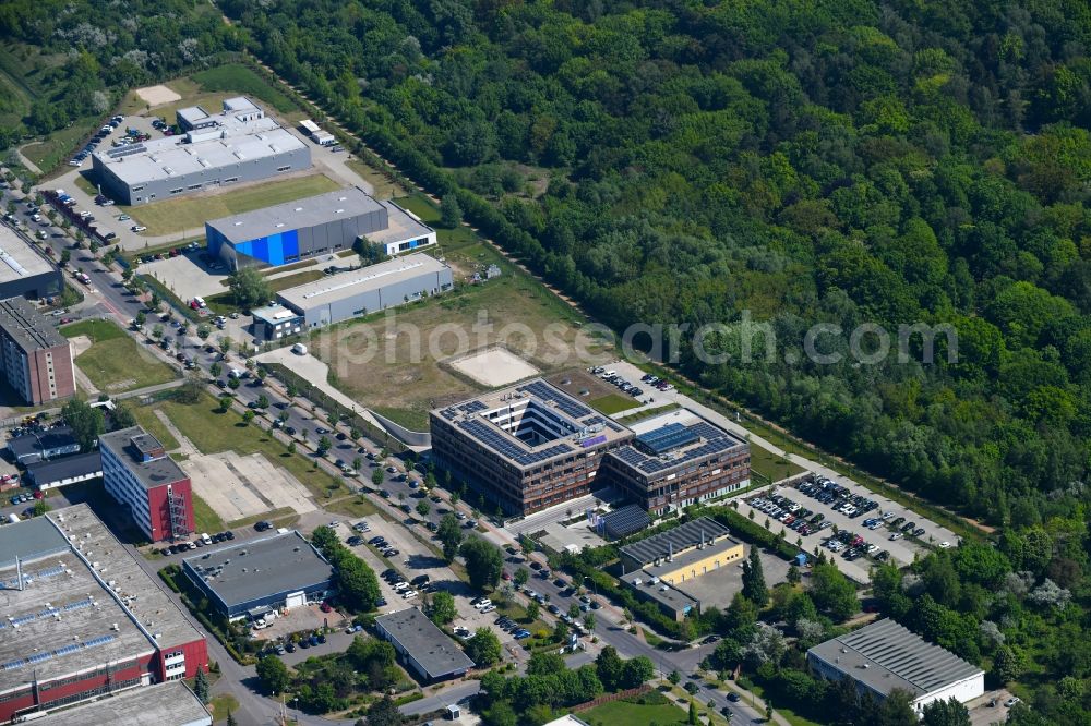Berlin from above - Construction site of the new company building of Flexim GmbH with a wooden facade on Boxberger Strasse in the district of Marzahn in Berlin
