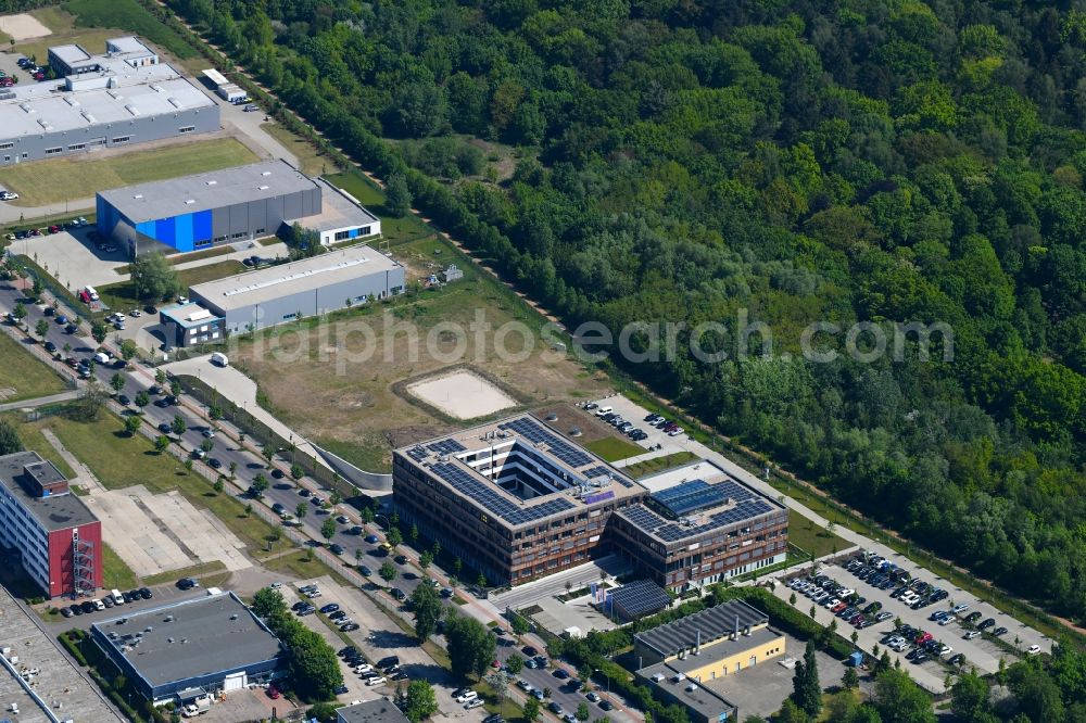 Berlin from the bird's eye view: Construction site of the new company building of Flexim GmbH with a wooden facade on Boxberger Strasse in the district of Marzahn in Berlin
