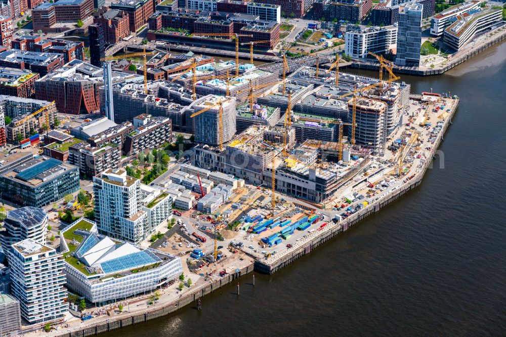 Hamburg from the bird's eye view: Construction site for the new building complex of the shopping center at Ueberseequartier at Strandkai in the Hafencity district in Hamburg, Germany