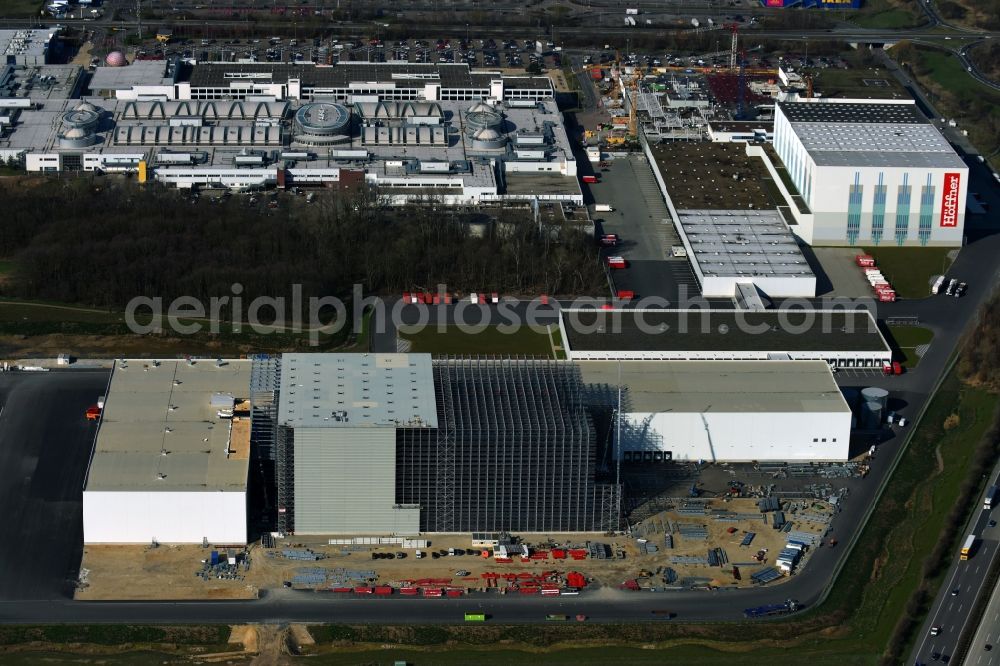 Günthersdorf from the bird's eye view: Construction site and assembly work for the construction of a high-bay warehouse building complex and logistics center on the premises of Hoeffner Moebelgesellschaft GmbH & Co.KG in Guenthersdorf in the state Saxony-Anhalt