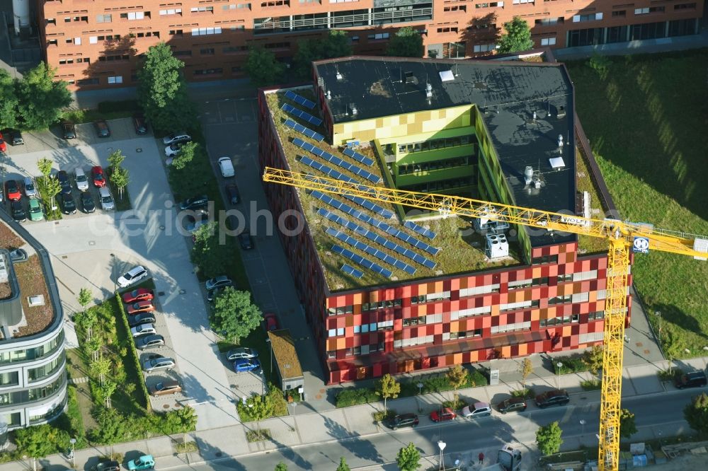 Leipzig from the bird's eye view: New laboratory and office building Bio Cube in Leipzig in the state of Saxony. The distinct red building is located on Perlickstrasse next to the Old Messe Leipzig. It belongs to the complex of Bio City Leipzig and includes laboratories and offices