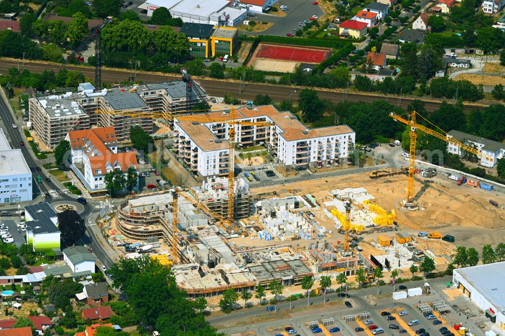 Falkensee from the bird's eye view: Construction site to build a new multi-family residential complex Merlin-Quartier on street Dallgower Strasse - Schwartzkopffstrasse in Falkensee in the state Brandenburg, Germany