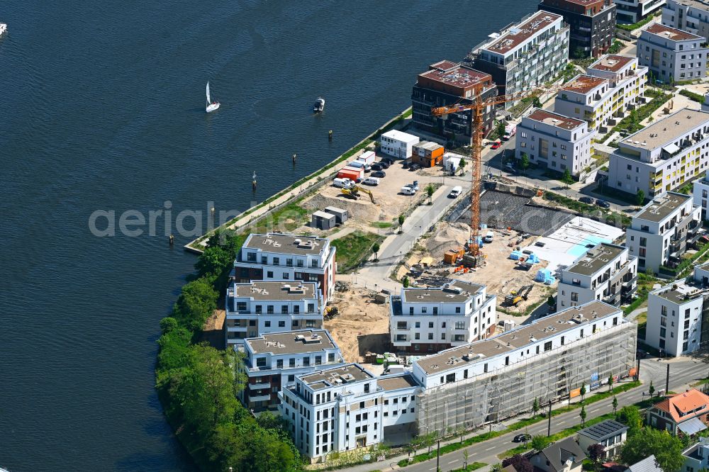 Berlin from above - Construction site for the new construction of a multi-family residential complex on the banks of the river Dahme at An der Bruecke - Regattastrasse - Ankerweg in the Gruenau district of Berlin, Germany