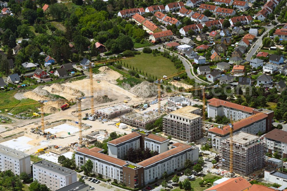 Falkensee from the bird's eye view: Construction site to build a new multi-family residential complex Schwarzbrunner Strasse - Rotkehlchenstrasse on street Falkenstrasse in Falkensee in the state Brandenburg, Germany