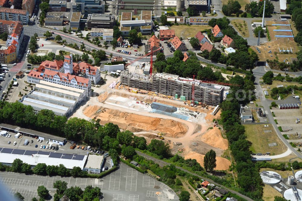Nürnberg from the bird's eye view: Construction site to build a new multi-family residential complex with condominiumson Tramliving Adolf-Braun-Strasse in the district Muggenhof in Nuremberg in the state Bavaria, Germany