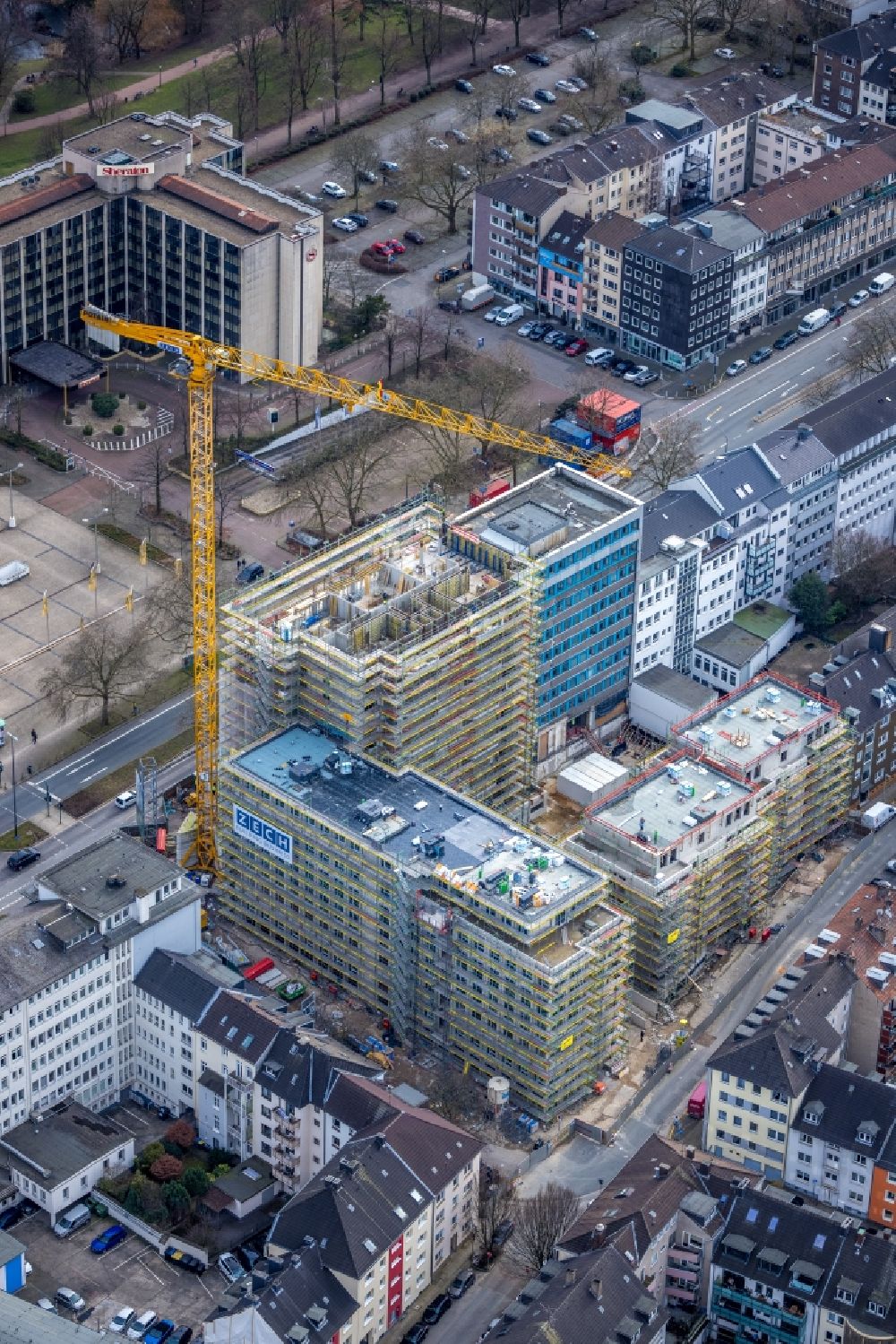 Essen from the bird's eye view: Construction site to build a new residential and commercial building HQE Huyssen Quartier Essen with residential tower and senior citizens' apartments on Huyssenallee - corner of Heinrichstrasse in Essen in the Ruhr area in the state North Rhine-Westphalia, Germany