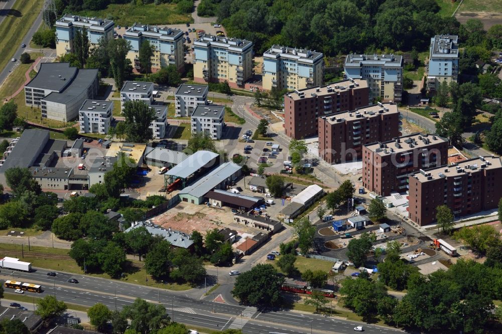 Aerial image Warschau - New residential buildings and industrial sites in the borough of Praga Polnoc in Warsaw in Poland. The blocks consist of 6 blue-yellow and 4 red buildings. They are located near industrial sites and halls and a small forest area at the state road 61