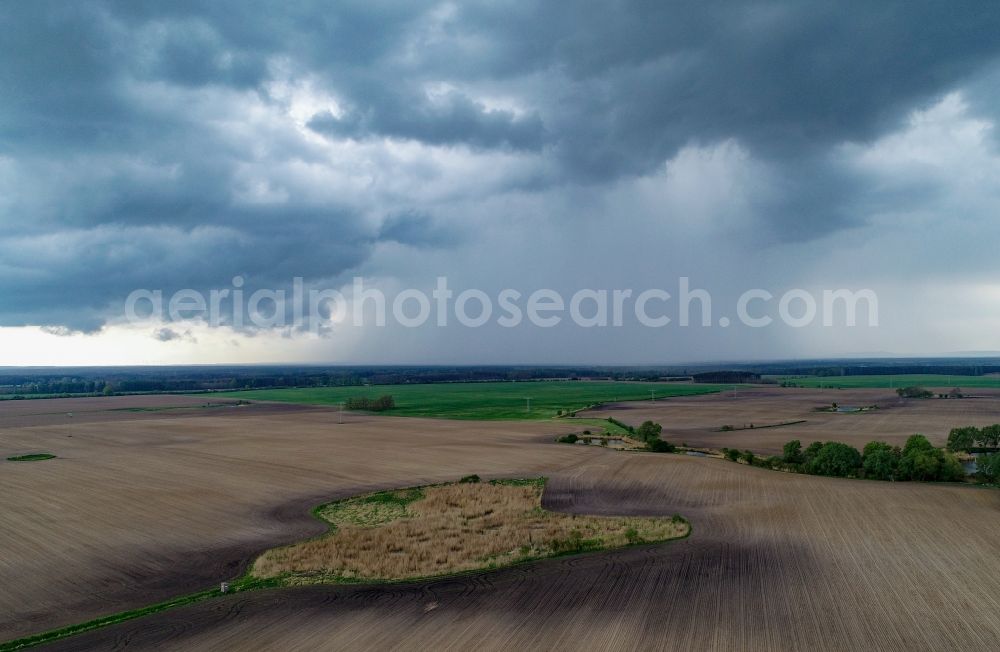 Aerial image Jacobsdorf - Rain clouds with falling precipitation for the natural irrigation of the agricultural fields in Jacobsdorf in the state Brandenburg, Germany