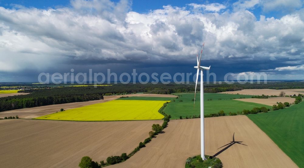Sieversdorf from the bird's eye view: Rain clouds with falling precipitation for the natural irrigation of the agricultural fields with yellow rapeseed flowers in Sieversdorf in the state Brandenburg, Germany