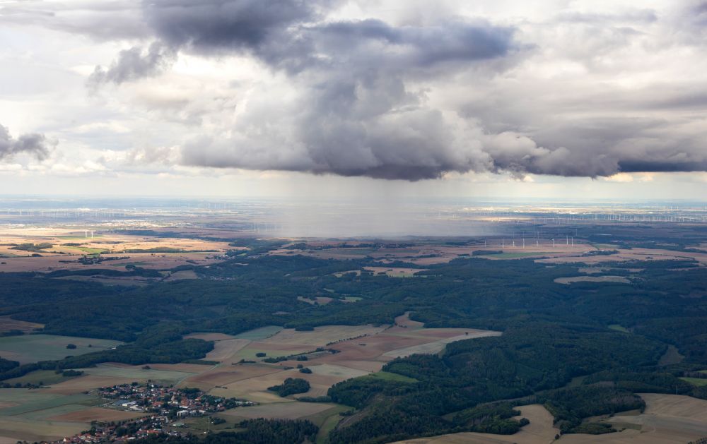 Wiesenburg/Mark from above - Rain clouds with falling precipitation for the natural irrigation of the agricultural fields in Wiesenburg/Mark in the state Brandenburg, Germany