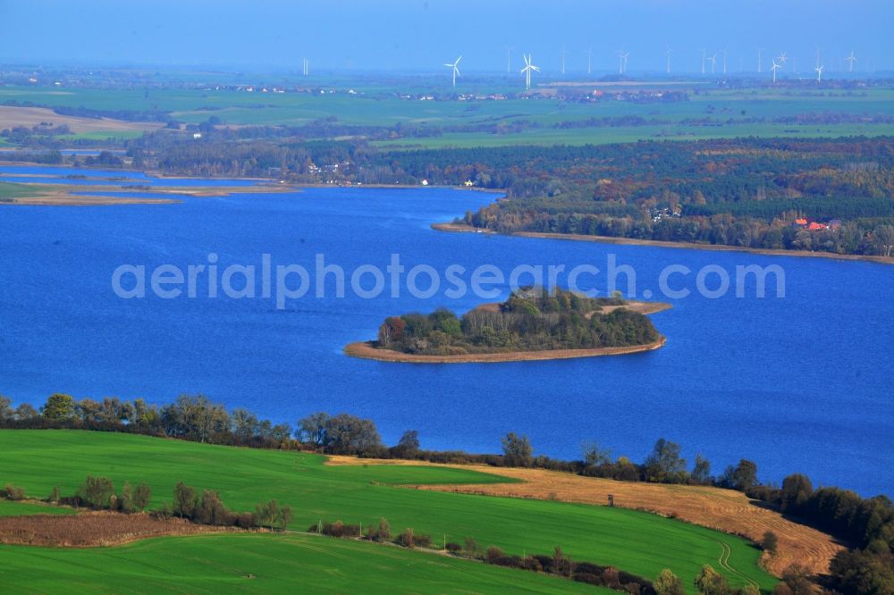 Aerial photograph Flieth-Stegelitz - View of the Oberuckersee from the Southwest. Large lake with trees densely vegetated island. In the background of forest and field landscape with wind turbines in Flieth-Stegelitz in the state of Brandenburg