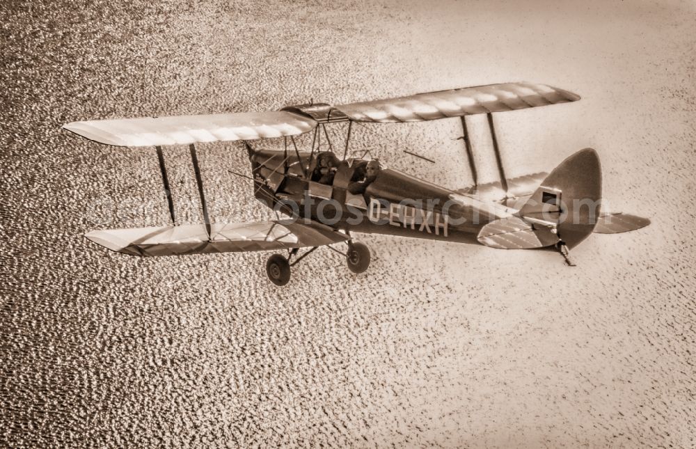 Aerial image Glücksburg - Vintage plane in flight over the Baltic Sea in the Flensburg Fjord airspace in Schleswig-Holstein. Historical biplane De Havilland DH-2 Tiger Moth with registration D-EHXH