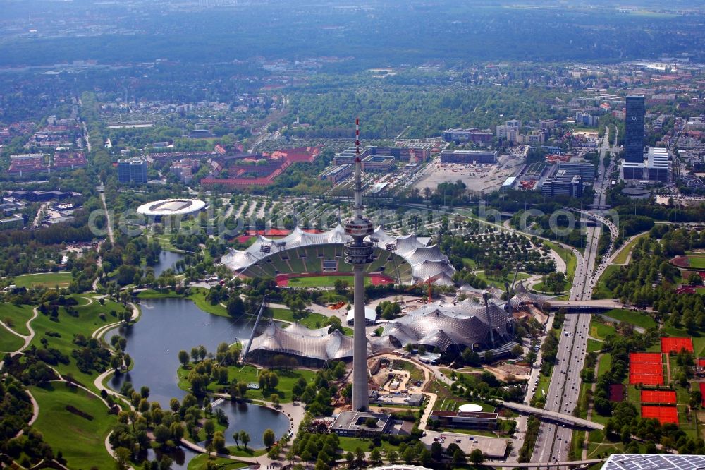 München from the bird's eye view: The Olympic Stadium in Munich, the Olympic Tower, the Olympic Hall, the cycling stadium and the Olympia Lake the key elements of the central sports facility Olympic Park and were the main locations in the 1972 Summer Olympics in Munich in Bavaria. The group of architects designed the modern Olympic Park Sports and event facilities as part of landscaping within the meaning of the concept of Olympic Games in the countryside. In the office tower in the background by the communication group Telefónica Germany GmbH has its headquarters