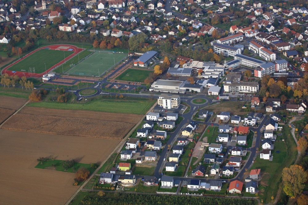 Aerial photograph Efringen-Kirchen - Town view of the streets and houses in the town center, at the sports facilities, the school center, the development area Giessenfeld and the community center with residential areas in Efringen-Kirchen in the state of Baden-Wuerttemberg