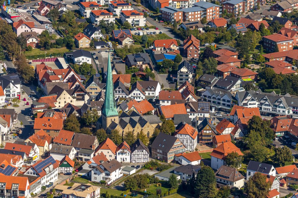 Aerial image Delbrück - View of the streets and houses of the residential areas and the Catholic Church Sankt Johannes Baptist in Delbrueck in the state North Rhine-Westphalia, Germany