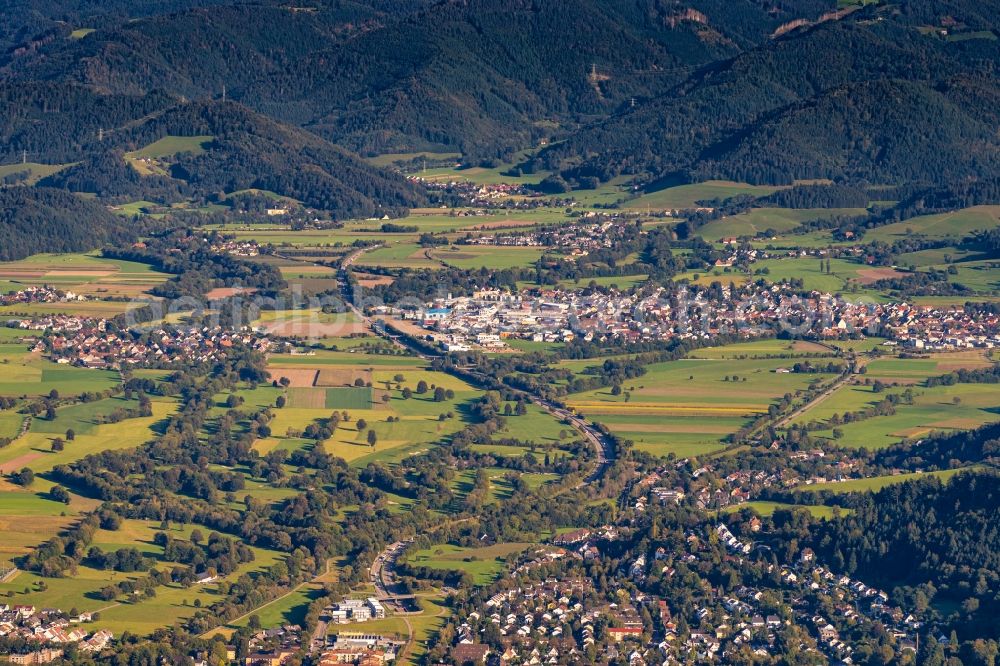 Aerial photograph Kirchzarten - Location view of the streets and houses of residential areas in the valley landscape surrounded by mountains in Kirchzarten in the state Baden-Wuerttemberg, Germany