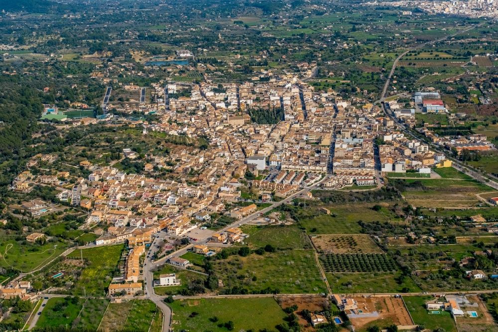 Aerial image Lloseta - Town view of the streets and houses of the residential areas in Lloseta with Inca in the background in Balearic island Mallorca, Spain