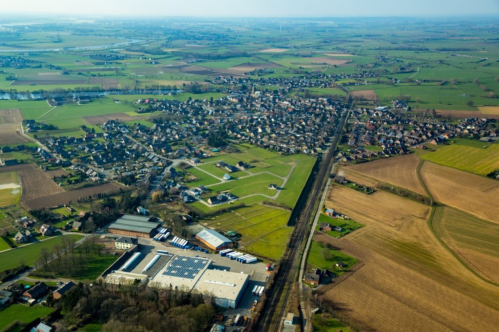 Aerial image Millingen - View of the village of Millingen with a logistics center and a rail line in the state of North Rhine-Westphalia
