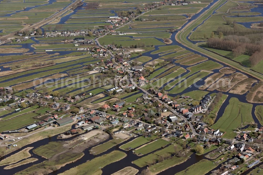 Aerial image Oostzaan - Town View of the streets and houses of the residential areas in Oostzaan in Noord-Holland, Netherlands