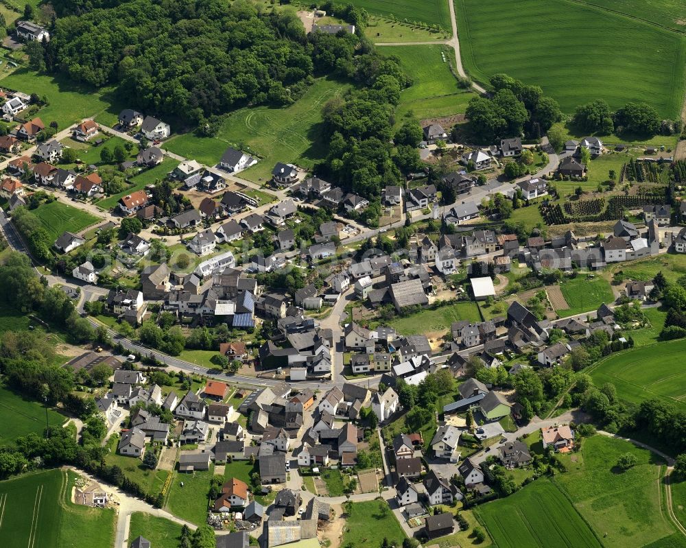 Glees from the bird's eye view: View of the borough of Glees in the state of Rhineland-Palatinate. Glees is an official tourist resort and is located in a valley of the Eifel region. It is surrounded by hills, fields and wooded areas
