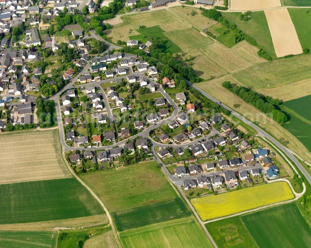 Aerial photograph Holzhausen an der Haide - View of the borough of Holzhausen an der Haide in the state of Rhineland-Palatinate. The borough and municipiality is located in the county district of Rhine-Lahn, in the Western Hintertaunus mountain region. The agricultural village consists of residential areas and is surrounded by rapeseed fields and meadows. It is located on the federal highways B260 and B274