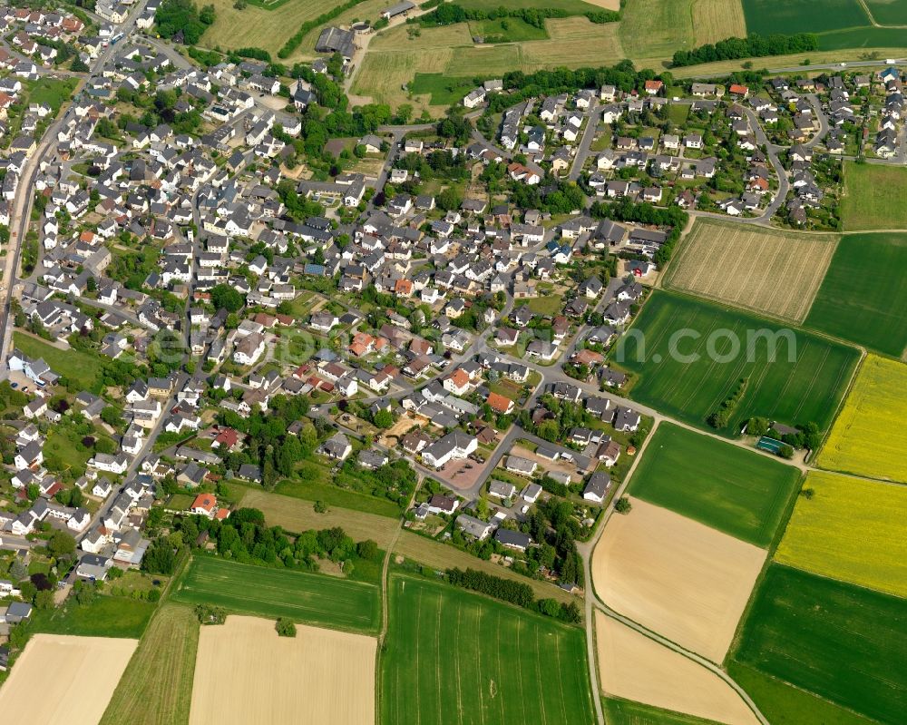 Holzhausen an der Haide from above - View of the borough of Holzhausen an der Haide in the state of Rhineland-Palatinate. The borough and municipiality is located in the county district of Rhine-Lahn, in the Western Hintertaunus mountain region. The agricultural village consists of residential areas and is surrounded by rapeseed fields and meadows. It is located on the federal highways B260 and B274