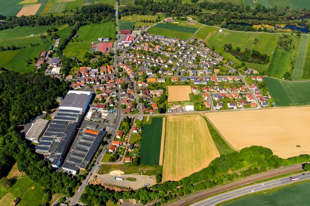 Aerial photograph Bad Wildungen - Town View of the streets and houses of the residential areas overlooking the work premises and production buildings of the Krausz Logistic und Lagerung GmbH on Ederstrasse in the district Wega in Bad Wildungen in the state Hesse, Germany