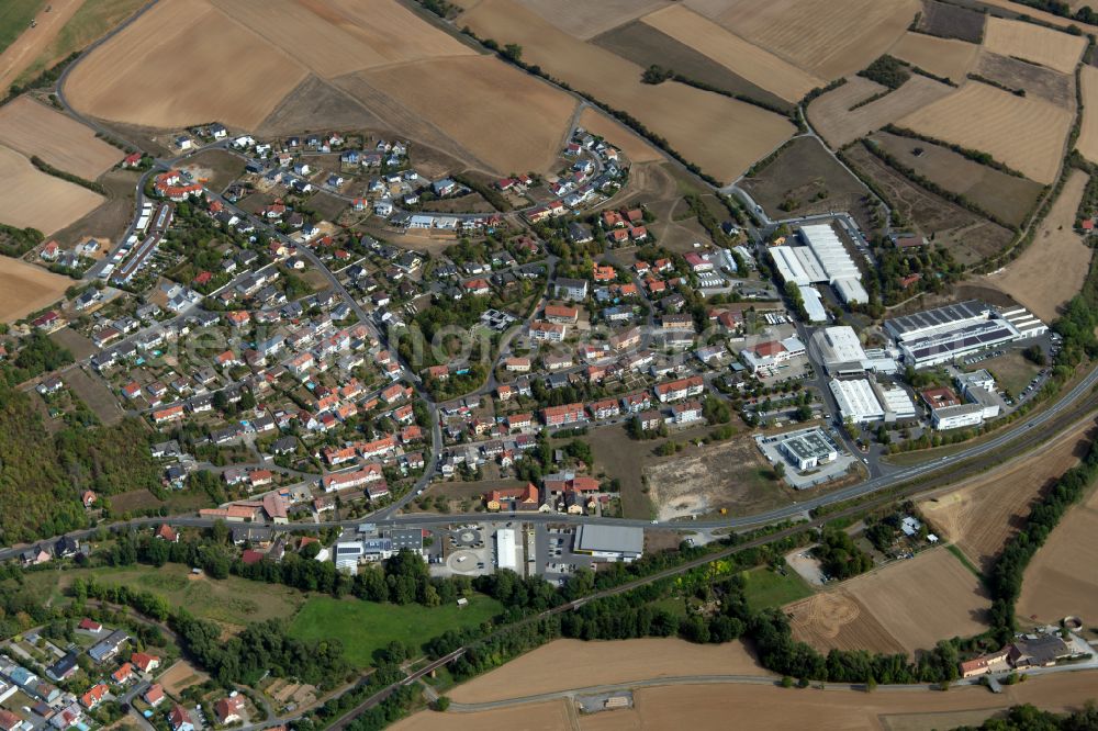 Arnstein from above - Village view on the edge of agricultural fields and land in Arnstein in the state Bavaria, Germany