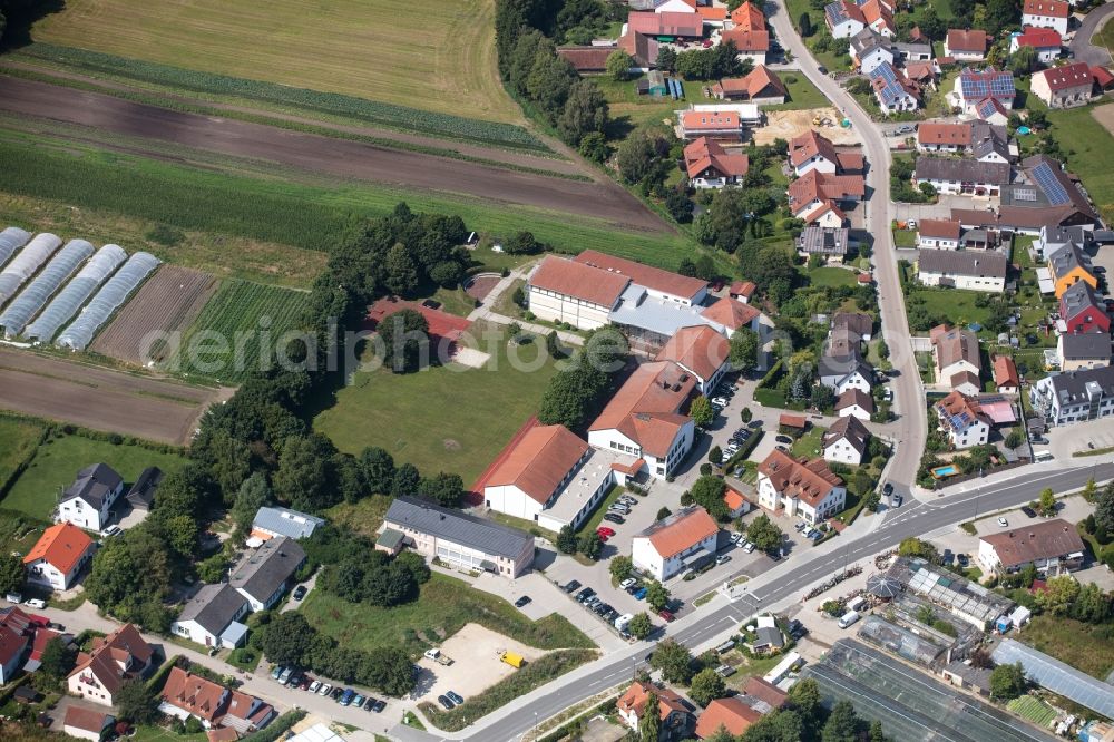Fahrenzhausen from the bird's eye view: Village view on the edge of agricultural fields and land in Fahrenzhausen in the state Bavaria, Germany