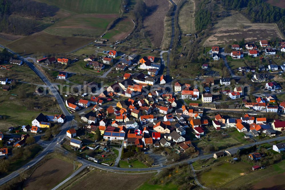 Frickenhausen from above - Village view on the edge of agricultural fields and land in Frickenhausen in the state Bavaria, Germany
