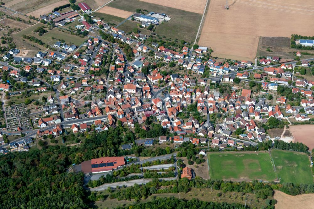 Gambach from the bird's eye view: Village view on the edge of agricultural fields and land in Gambach in the state Bavaria, Germany