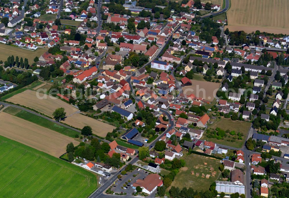 Giebelstadt from above - Village view on the edge of agricultural fields and land in Giebelstadt in the state Bavaria, Germany