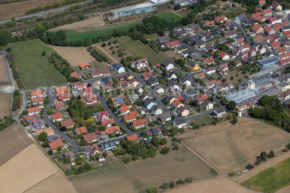 Gänheim from the bird's eye view: Village view on the edge of agricultural fields and land in Gänheim in the state Bavaria, Germany